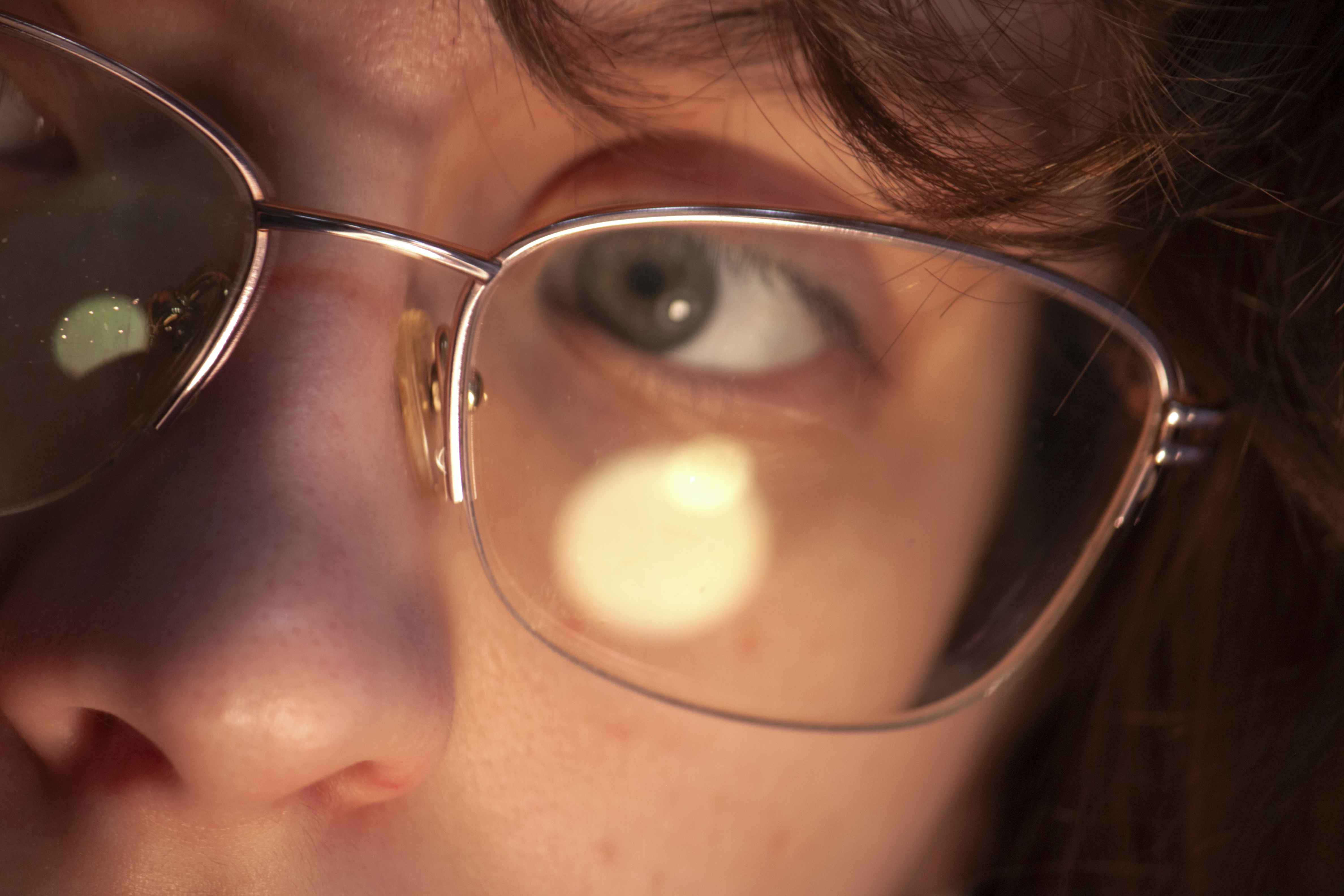 a close up photo of the eyes of a woman wearing glasses.
